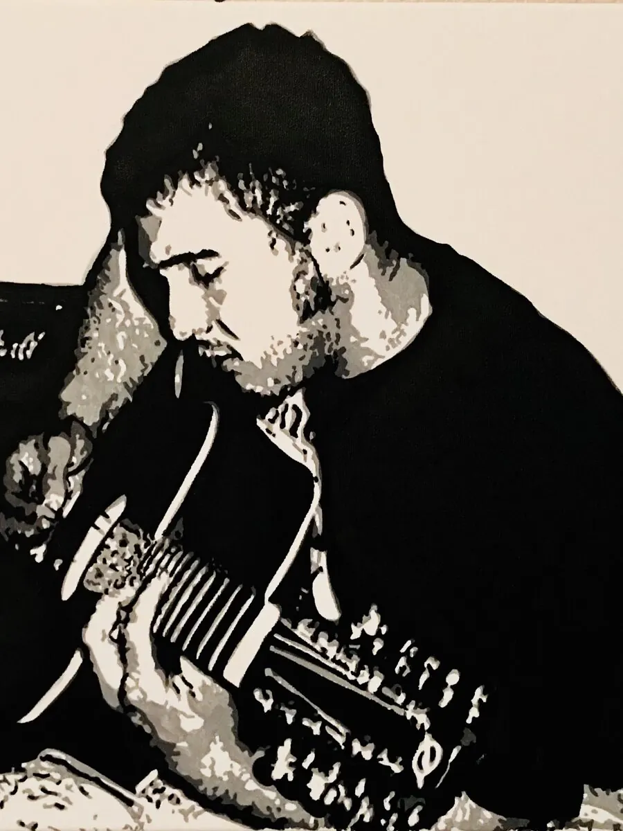 Black and white acrylic painting of a young man playing an acoustic guitar